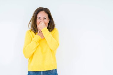 İzole arka plan kokulu üzerinde sarı kazak pis ve iğrenç bir şey, dayanılmaz koku, holding nefes parmak ile burun üzerinde giyen güzel orta yaş kadın. Kötü kokuyor kavramı.