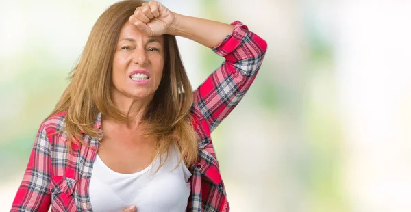 Beautiful middle age woman wearing over isolated background Touching forehead for illness and fever, flu and cold, virus sick