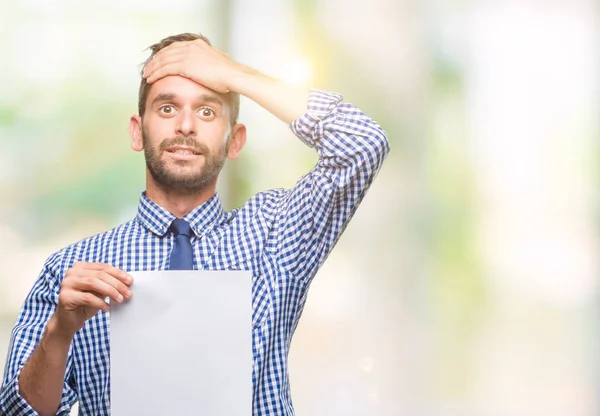 Joven Hombre Guapo Sosteniendo Papel Blanco Sobre Fondo Aislado Estresado —  Fotos de Stock