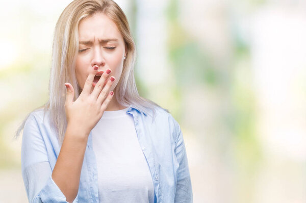 Young blonde woman over isolated background bored yawning tired covering mouth with hand. Restless and sleepiness.