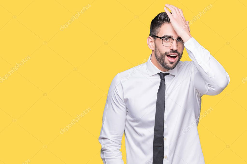 Young handsome business man wearing glasses over isolated background surprised with hand on head for mistake, remember error. Forgot, bad memory concept.