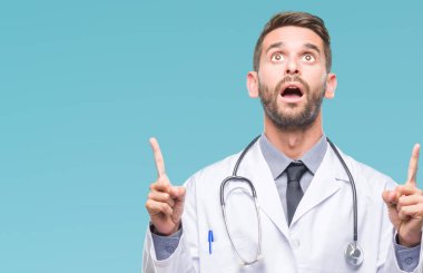 Genç yakışıklı Doktor adam izole arka plan üzerinden hayran ve yukarıya bakıp parmakları ile işaret şaşırttı ve silah kaldırdı.