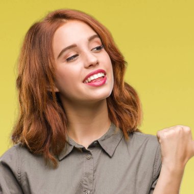 Seyir ve başparmak yanında yukarıyı mutlu yüz ile gülümseyen izole arka plan üzerinde genç güzel kadın.