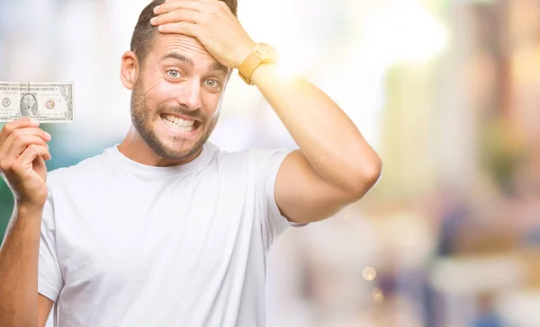 Jovem Homem Bonito Segurando Dólares Sobre Fundo Isolado Estressado Com — Fotografia de Stock