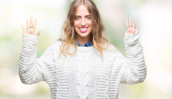 Beautiful young blonde woman wearing winter sweater over isolated background showing and pointing up with fingers number nine while smiling confident and happy.