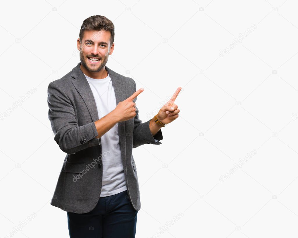 Young handsome business man over isolated background smiling and looking at the camera pointing with two hands and fingers to the side.