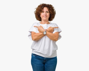 Arka plan üzerinde beyaz t-shirt giyen kadın güzel orta ager kıdemli izole her iki parmak ile işaret eden, farklı yönde katılmıyorum