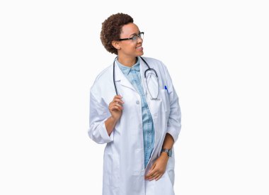 Üzerinde tıbbi ceket giyen genç Afro-Amerikan doktor kadın arka plan uzak tarafına gülümseme ile yüzünde, doğal ifade arıyorum izole. Kendine güvenen gülüyor.