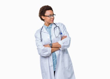 İkna ve kendine güvenen genç Afro-Amerikan doktor kadın tarafına silahlarla seyir gülümseyen izole arka plan üzerinde tıbbi bir palto giyiyor geçti