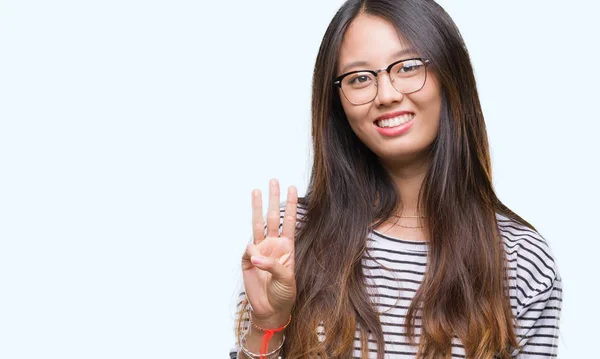 若いアジア女性分離背景表示と指で上向きに眼鏡をかけて番号自信を持って 幸せな笑みを浮かべている間 — ストック写真
