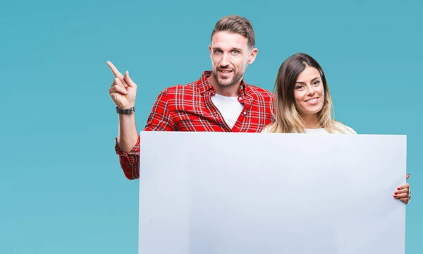 Young Couple Together Holding Blank Banner Isolated Background Very Happy — Stock Photo, Image