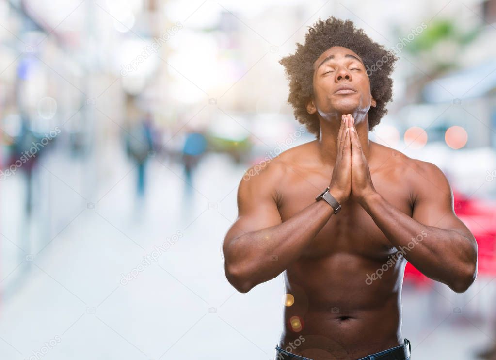 Afro american shirtless man showing nude body over isolated background begging and praying with hands together with hope expression on face very emotional and worried. Asking for forgiveness. Religion concept.