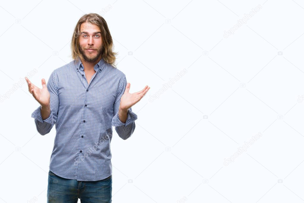 Young handsome man with long hair over isolated background clueless and confused expression with arms and hands raised. Doubt concept.