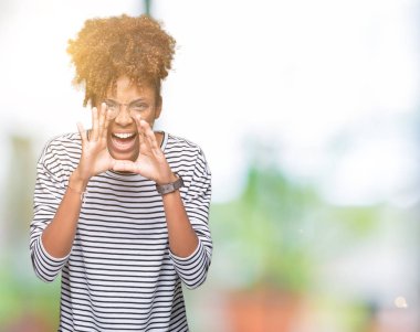 Eller ile kızgın yüksek sesle bağırarak izole arka plan üzerinde gözlük güzel genç Afro-Amerikan kadın ağzına