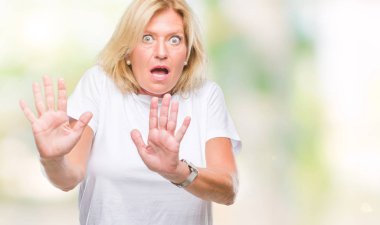 Middle age blonde woman over isolated background afraid and terrified with fear expression stop gesture with hands, shouting in shock. Panic concept. clipart