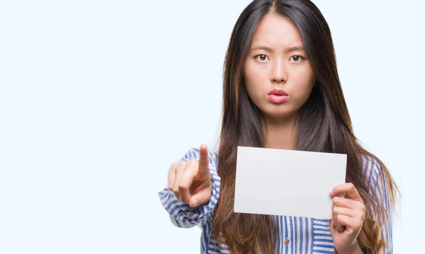 Joven Mujer Asiática Sosteniendo Tarjeta Blanco Sobre Fondo Aislado Señalando —  Fotos de Stock