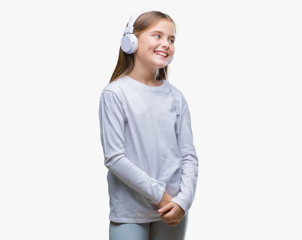 Young Beautiful Girl Wearing Headphones Listening Music Isolated Background Looking — Stock Photo, Image