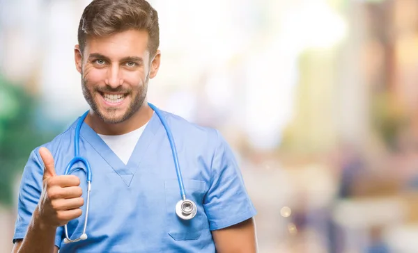 Young Handsome Doctor Surgeon Man Isolated Background Doing Happy Thumbs — Stock Photo, Image