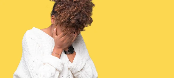 Beautiful young african american woman wearing winter sweater over isolated background with sad expression covering face with hands while crying. Depression concept.