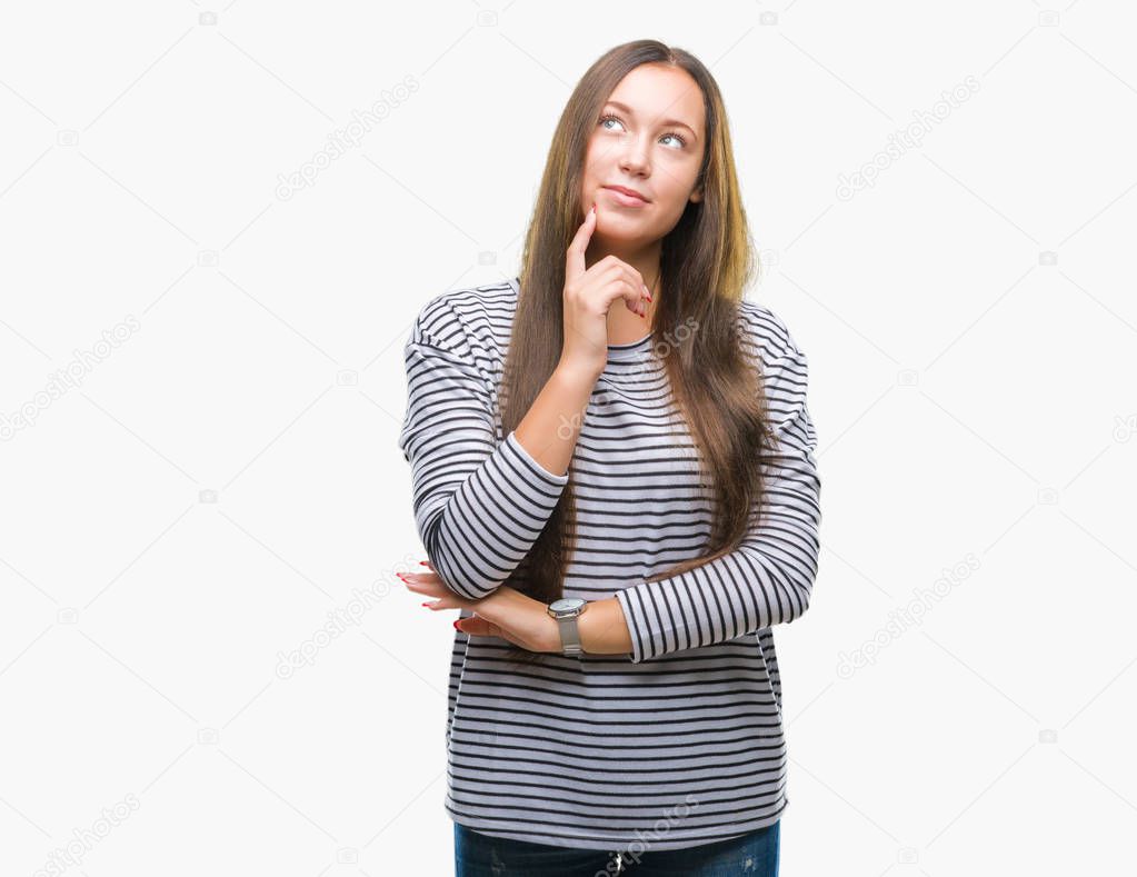 Young beautiful caucasian woman over isolated background with hand on chin thinking about question, pensive expression. Smiling with thoughtful face. Doubt concept.