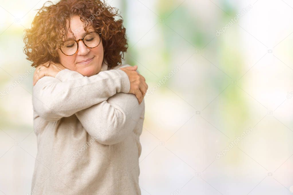 Beautiful middle ager senior woman wearing turtleneck sweater and glasses over isolated background Hugging oneself happy and positive, smiling confident. Self love and self care