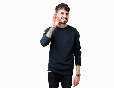 Yakışıklı delikanlı bir işitme söylenti ya da dedikodu için dinleme kulak üzerinde el ile gülümseyen izole arka plan üzerinde. Sağırlık kavramı.