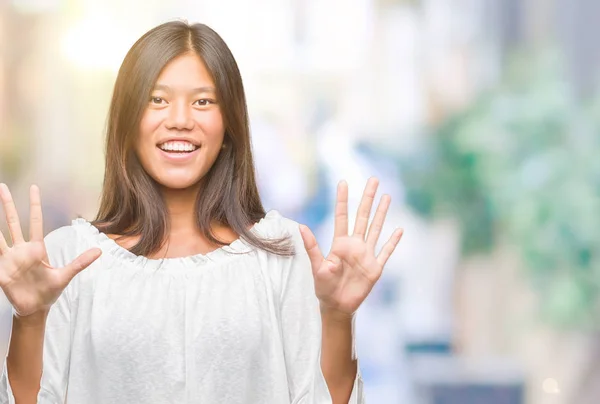 Young Asian Woman Isolated Background Showing Pointing Fingers Number Ten — Stock Photo, Image