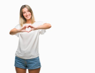 Genç güzel kadın kalp simgesi ve elleriyle şekil gösterilen aşık gülümseyen izole arka plan yüzünden. Romantik kavramı.