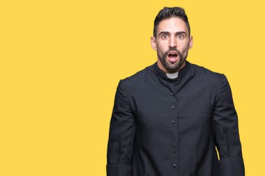 Genç Hıristiyan rahip izole arka plan korkuyor ve şok sürpriz ifade, korku ve heyecan yüz üzerinden.