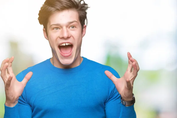 Joven Hombre Guapo Con Suéter Azul Sobre Fondo Aislado Loco —  Fotos de Stock