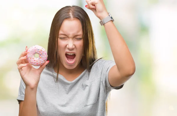 Young Caucasian Woman Eating Sweet Donut Isolated Background Annoyed Frustrated — Stock Photo, Image