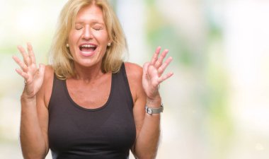 Orta yaş sarışın kadın izole arka plan çılgın ve kızgın bağırarak ve agresif ifade ve silah kaldırdı bağırıyor. Hayal kırıklığı kavramı.