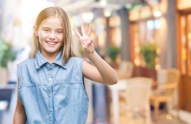 Genç güzel kız gösterilen ve parmakları ile işaret izole arka plan üzerinde üçüncü ise kendinden emin ve mutlu gülümseyerek.