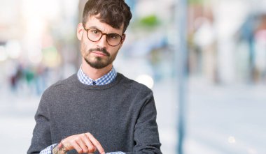 Genç yakışıklı zeki adam işaret seyretmek zaman, sabırsızlık, üzgün ve kızgın için son tarih gecikme için acele izole arka plan üzerinde gözlük