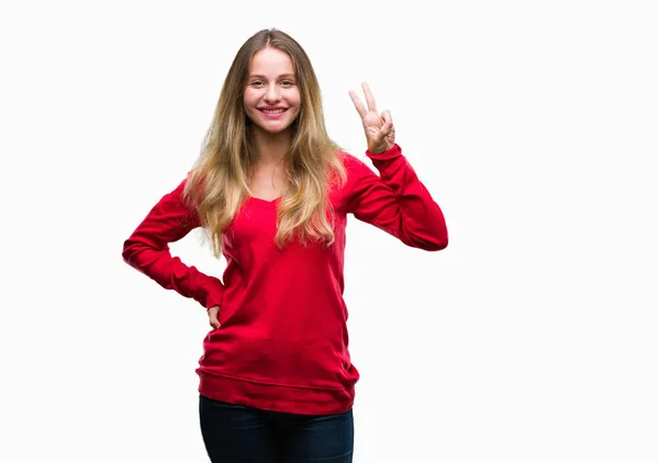 年轻美丽的金发女子穿着红色毛衣在孤立的背景显示和指向与手指第二 微笑自信和快乐 — 图库照片