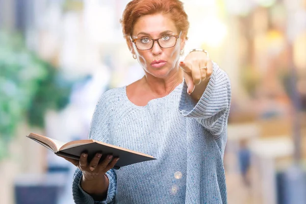 Senior Caucasian Woman Reading Book Isolated Background Pointing Finger Camera — Stock Photo, Image