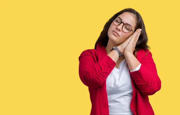 Beautiful plus size young business woman wearing elegant jacket and glasses over isolated background sleeping tired dreaming and posing with hands together while smiling with closed eyes.