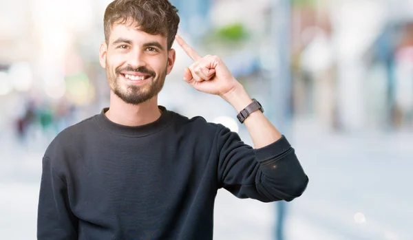 Junger Gutaussehender Mann Über Isoliertem Hintergrund Lächelnd Mit Einem Finger — Stockfoto