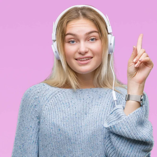 Young Caucasian Woman Listening Music Wearing Headphones Isolated Background Pointing — Stock Photo, Image