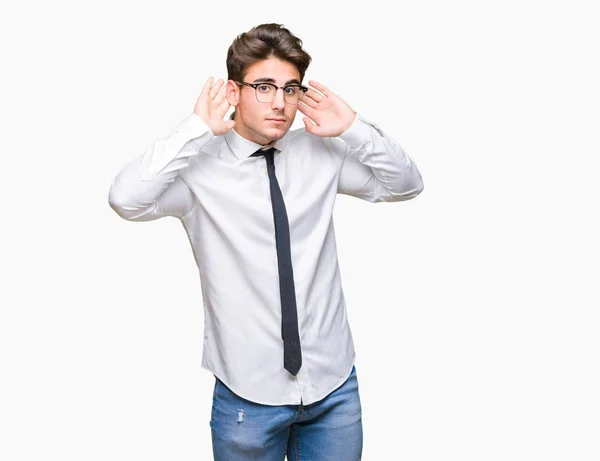 Joven Hombre Negocios Con Gafas Sobre Fondo Aislado Tratando Escuchar —  Fotos de Stock