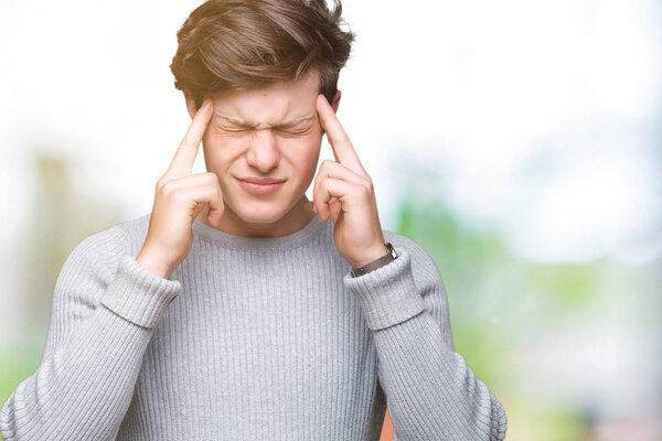 Young handsome man wearing winter sweater over isolated background with hand on head for pain in head because stress. Suffering migraine.