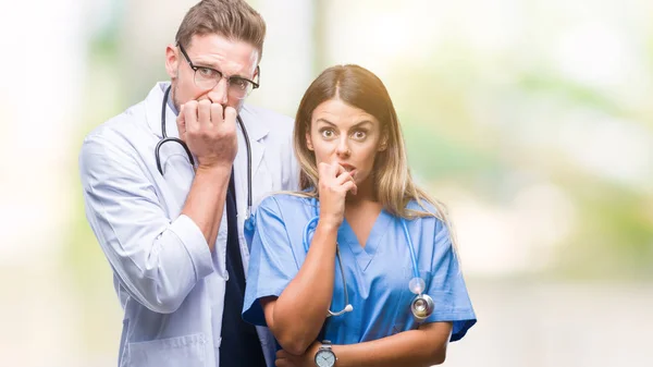 年轻夫妇的医生和外科医生在孤立的背景下看紧张和紧张的手在嘴咬指甲 焦虑问题 — 图库照片