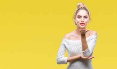 Bir öpücük el ile güzel ve seksi olmak hava üfleme kamera bakarak izole arka plan genç güzel sarışın ve mavi gözlü kadın. Aşk ifade.