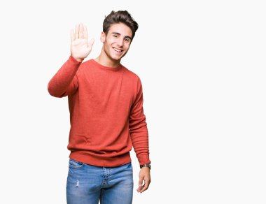 Yakışıklı delikanlı izole arka plan Waiving mutlu selam söyleyerek üzerinde ve gülümseyen, dostça karşılama jest