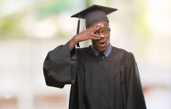Young Graduated African American Man Isolated Background Peeking Shock Covering — Stock Photo, Image