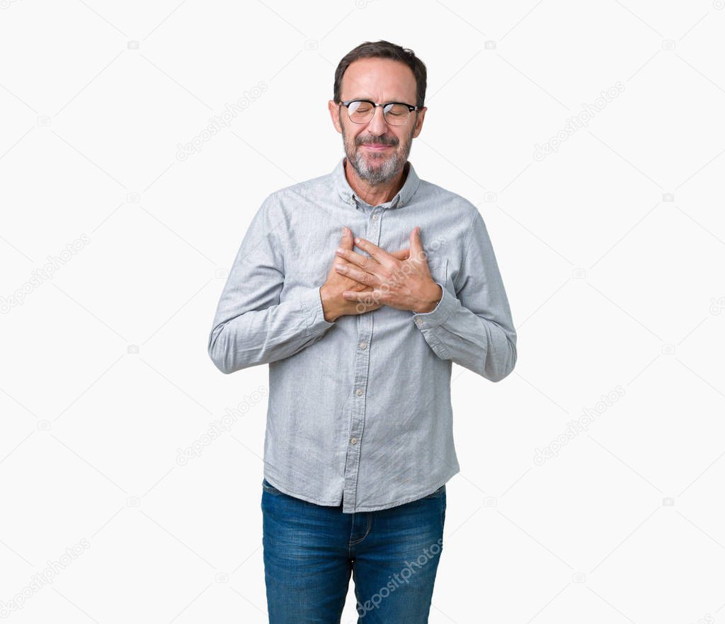 Handsome middle age elegant senior man wearing glasses over isolated background smiling with hands on chest with closed eyes and grateful gesture on face. Health concept.