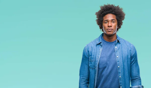 Afro american man over isolated background with serious expression on face. Simple and natural looking at the camera.