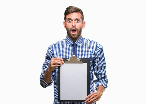 Young Handsome Business Man Holding Clipboard Isolated Background Scared Shock — Stock Photo, Image