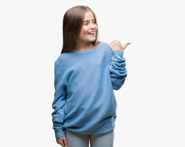 探していると親指側に上向きの幸せそうな顔を浮かべて隔離された背景に冬のセーターを着ている美しい少女 — ストック写真
