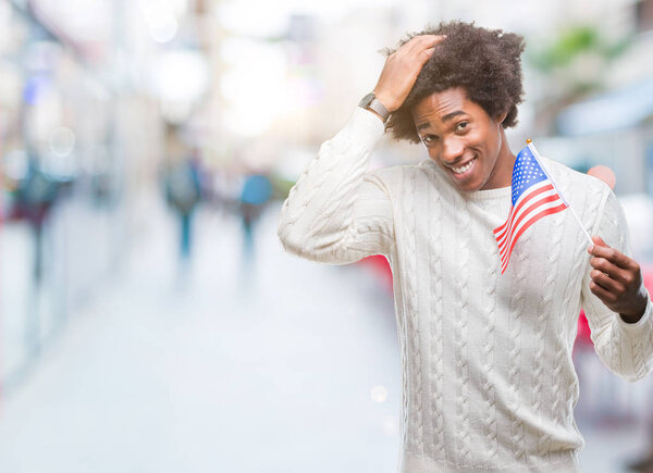 Afro american man flag of United States of America over isolated background stressed with hand on head, shocked with shame and surprise face, angry and frustrated. Fear and upset for mistake.